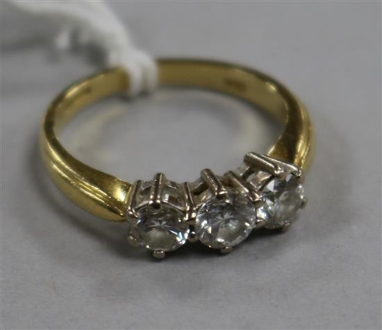 An 18ct gold and three stone diamond ring, size M.